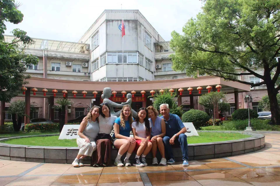 Travelers visiting a welfare institute in China as part of a private heritage return