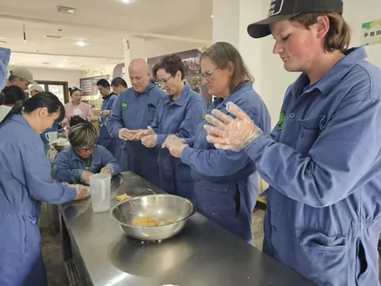 Travelers taking part in a panda care activity near Chengdu