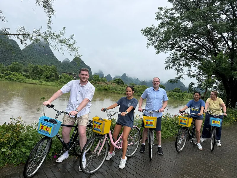 LeadToChina travelers cycling beside the river in the Yangshuo countryside